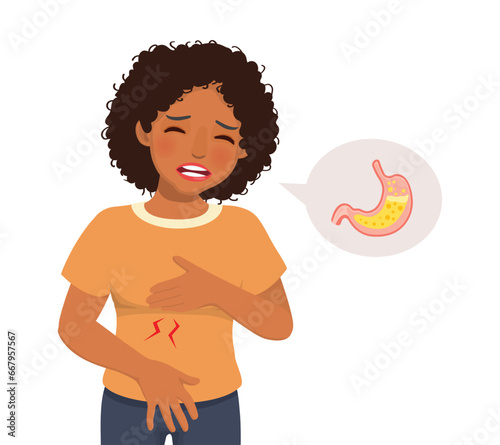 Young African woman suffering from acid reflux holding her chest feeling heartburn sensation
