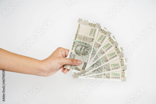 Indian rupee cash in hand on white background photo