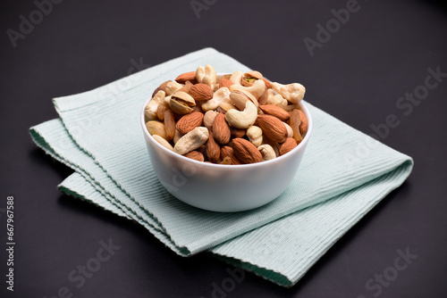 Mix nuts in bowl, cashews and almonds mix with pistachios and raisins