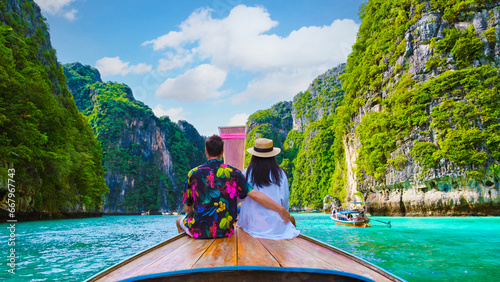 Couple in front of Longtail boat at the lagoon of Koh Phi Phi Thailand photo