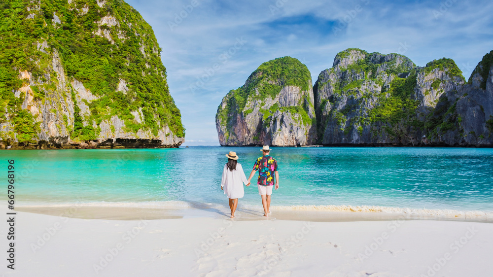 Couple in front of Longtail boat at the lagoon of Koh Phi Phi Thailand - obrazy, fototapety, plakaty 