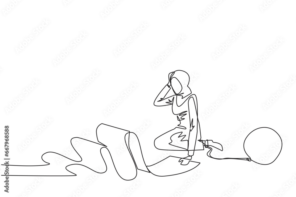Continuous one line drawing Arab businesswoman sits on the floor and feet are chained by a steel ball while holding a billing paper. Fooled by loan sharks. Single line draw design vector illustration