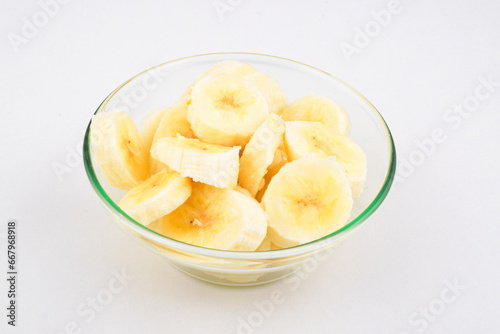 Banana slice in bowl on white background