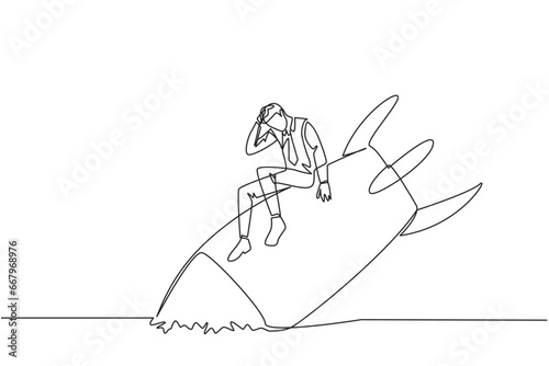 Continuous one line drawing of businessman sits downcast on a swooping rocket stranded and stuck at ground level. The new business was destroyed. Unable to pay bills. Single line draw design vector