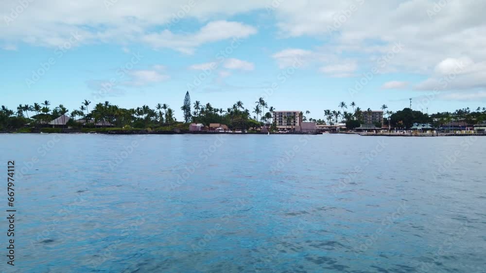 Gimbal wide POV shot from a moving boat approaching Kailua Bay on the Big Island of Hawai'i. 4K at 60 FPS Slow Motion