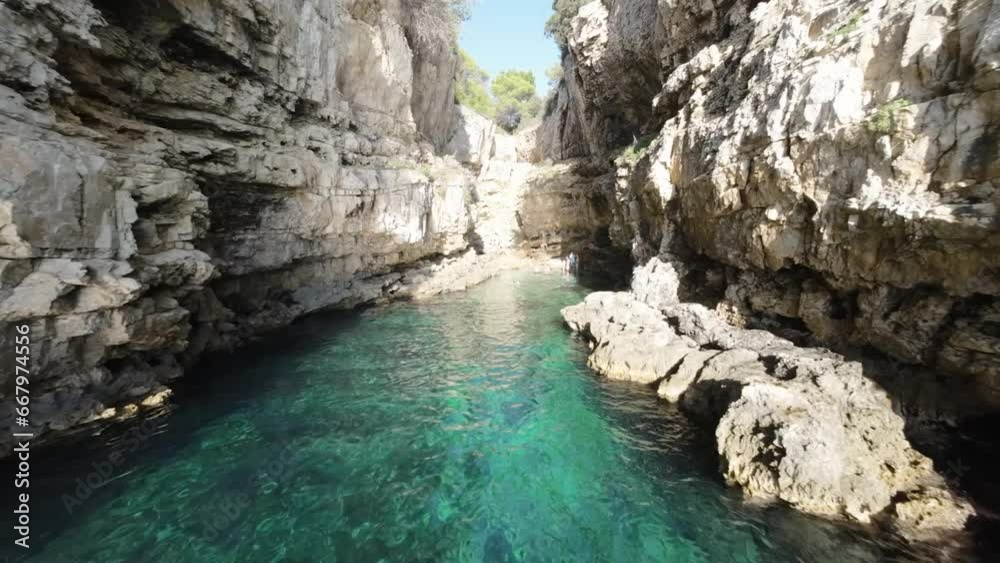 Secluded cove with turquoise waters between rugged cliffs Secluded cove with turquoise waters between rugged cliffs