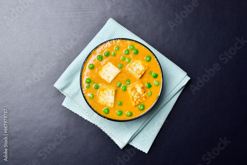 Matar paneer in bowl, top view of cottage cheese and peas curry photo