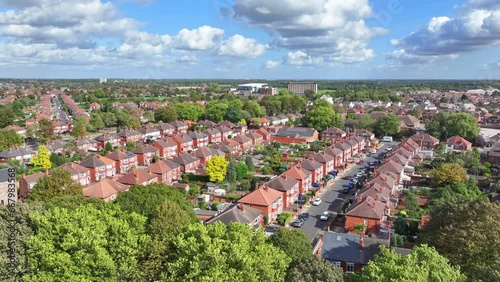 Drone descends treeline hiding typical English suburb of Doncaster England photo
