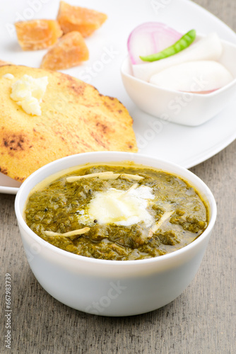 Closeup of sarso saag with white butter in bowl