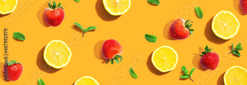 Fototapeta Naklejka Na Ścianę i Meble -  Fresh lemons and strawberries with mints overhead view - flat lay
