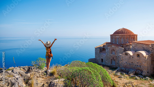 Traveler caucasian woman in Greece- typical orthodox church and mediterranean sea