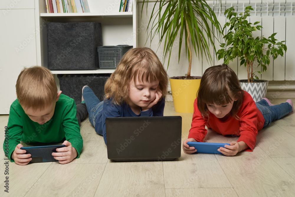 Children use electronics to learn, play and communicate. Generation alpha, digital natives. Children with laptop and phones Children use electronics to learn, play and communicate. Generation alpha, digital natives. Children with laptop and phones