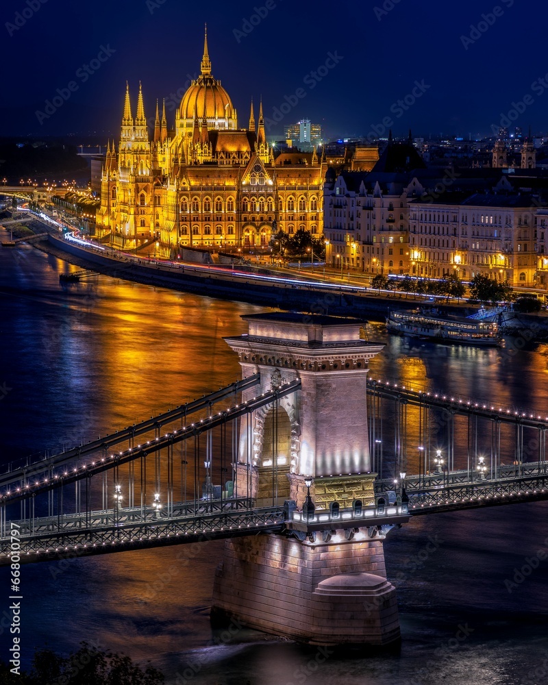 Illuminated aerial view of Budapest, Hungary, at night with the Chain Bridge over the Danube River