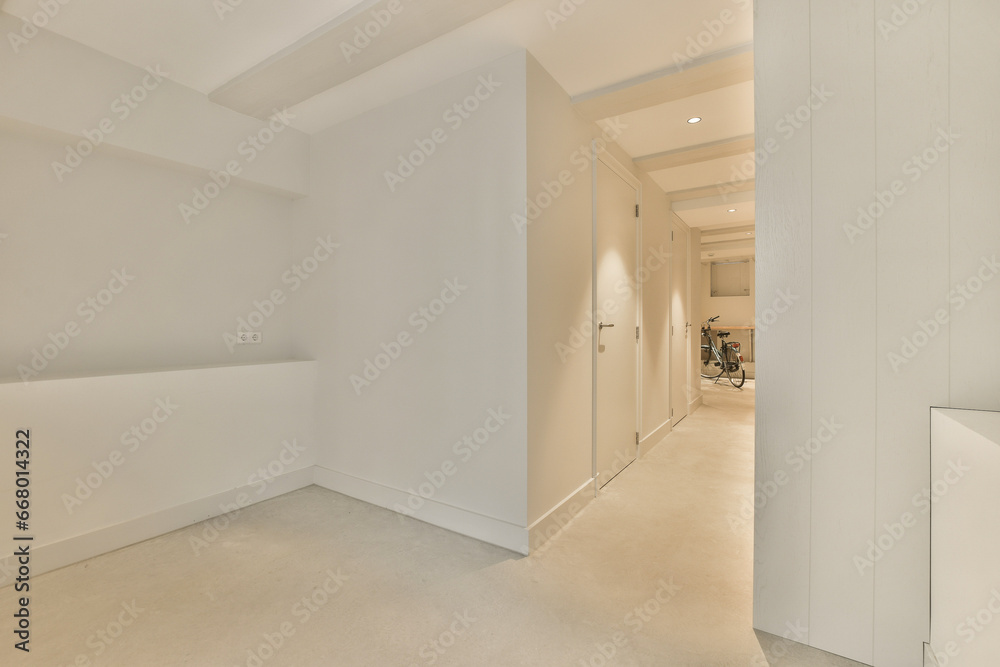 an empty room with white walls and beige carpet on the floor, there is a door leading to another room an empty room with white walls and beige carpet on the floor, there is a door leading to another room