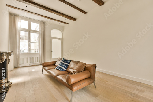 a living room with wood flooring and white walls, an old fire place in the corner of the room