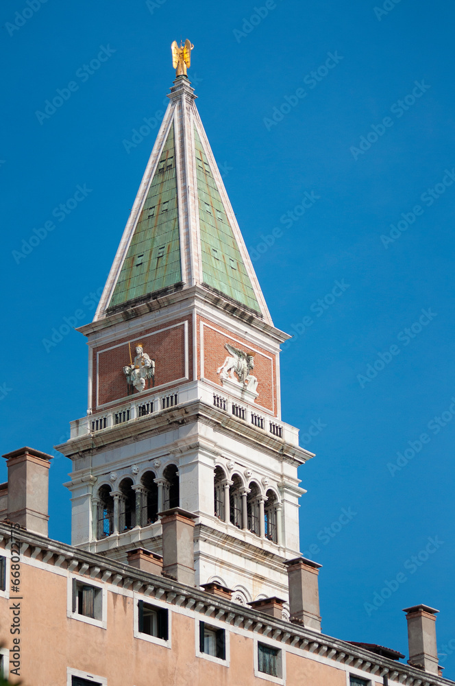 Obraz premium Piazza San Marco with top of Campanile di San Marco with golden angel on top at City of Venice on sunny summer day.