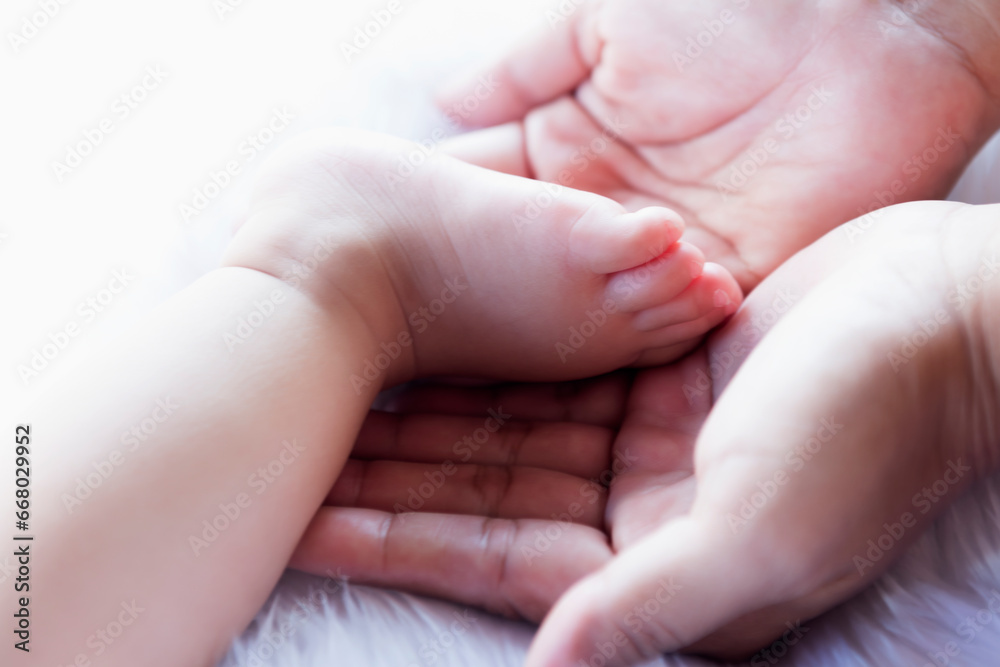 Baby feet in hand, mother, tiny newborn baby feet on hand, female photo, closeup, mother and her child, happy family concept, beautiful concept image of childbirth.
