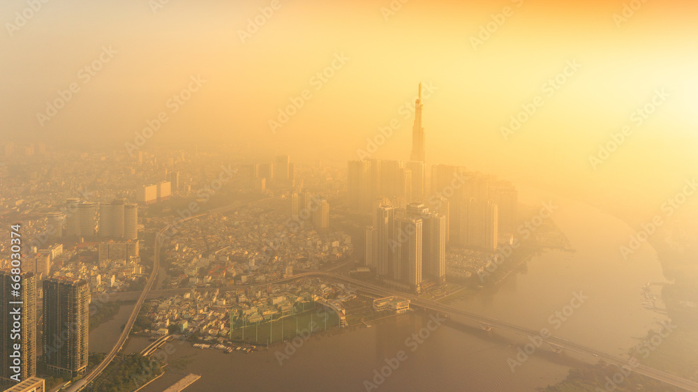 aerial view of early morning at Landmark 81 is a super tall skyscraper in center Ho Chi Minh City, Vietnam and Saigon bridge with development buildings, energy power infrastructure.