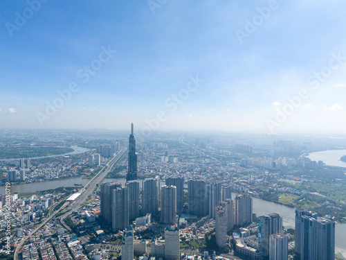 aerial view of early morning at Landmark 81 is a super tall skyscraper in center Ho Chi Minh City, Vietnam and Saigon bridge with development buildings, energy power infrastructure. © CravenA