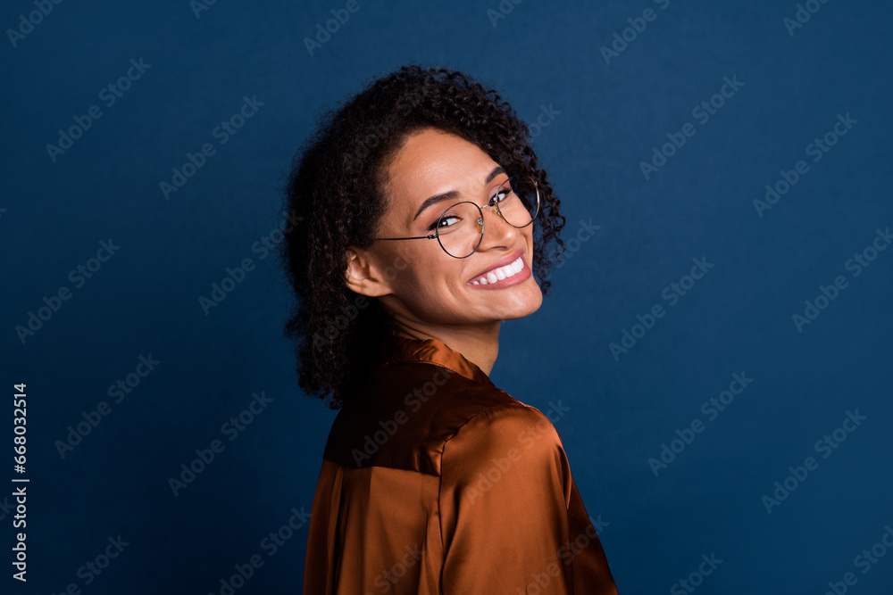 Photo of dreamy adorable lady wear silk brown shirt spectacles smiling isolated blue color background Photo of dreamy adorable lady wear silk brown shirt spectacles smiling isolated blue color background