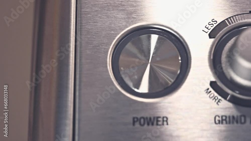 close-up of the buttons of a stainless steel expresso press machine for ground coffee photo