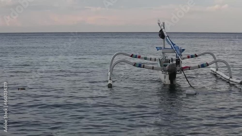 Badik boats float on the waters of Nusa Penida, Bali ahead of sunset. HD videos photo