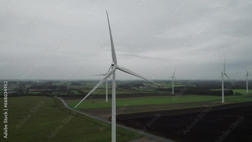 Large Windmill Farm on Field. Wind Turbines, Renewable Energy, Wind Energy - Drone View Large Windmill Farm on Field. Wind Turbines, Renewable Energy, Wind Energy - Drone View