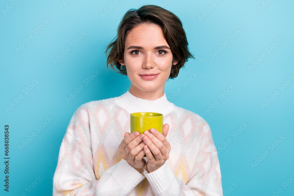Portrait of lovely positive peaceful person arms hold fresh coffee cup isolated on blue color background Portrait of lovely positive peaceful person arms hold fresh coffee cup isolated on blue color background