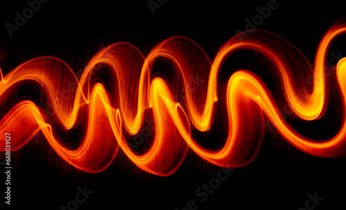Obraz na płótnie Light wave trail path, vibrant neon gold color in abstract swirls on a black background. w salonie