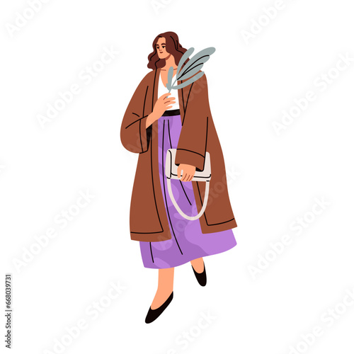 Young woman walking in fashion apparel, holding leaf plant in hand. Romantic ...