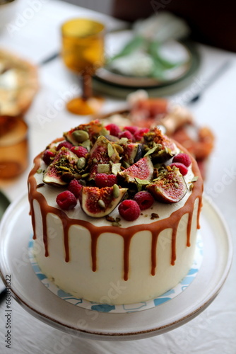 Cake with cream and ripe berries and nuts