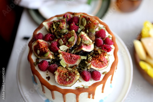 Cake with cream and ripe berries and nuts
