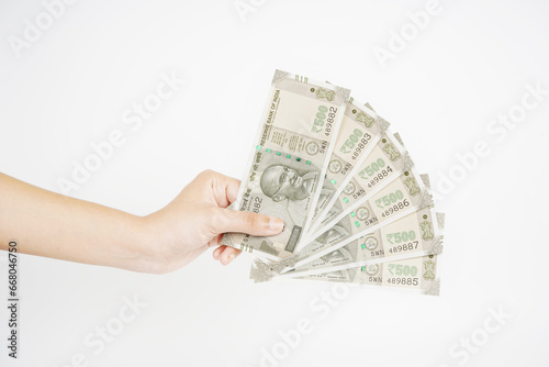 500 rupees banknote in hand isolated on white background photo