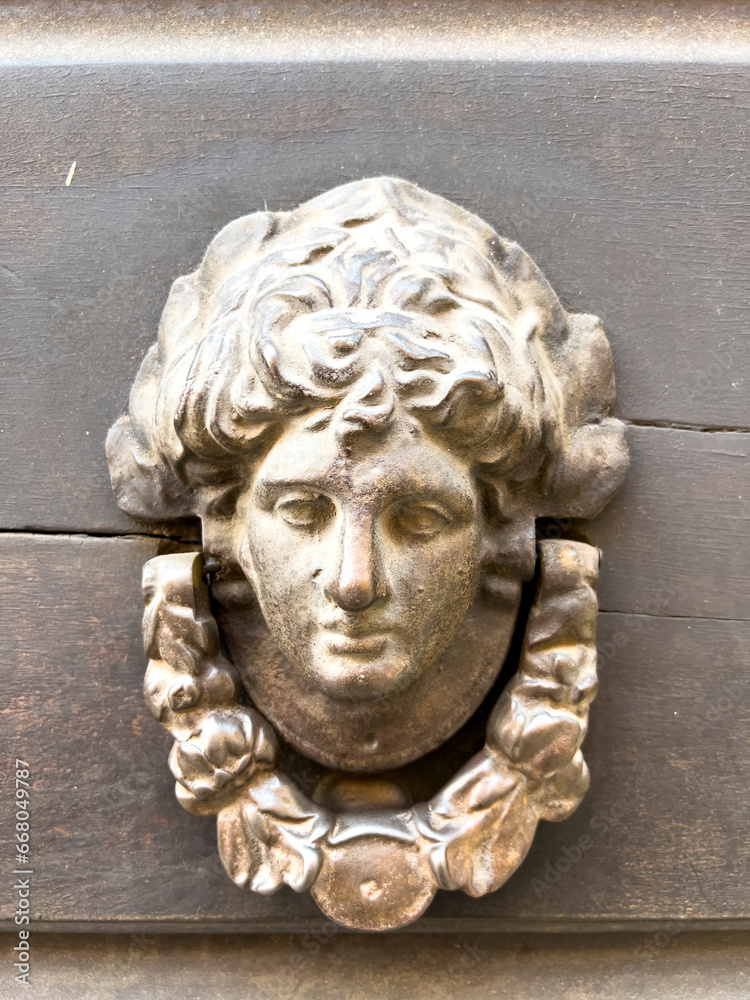 Brass door knocker with woman's head