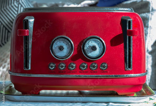 Red retro styled toaster for breakfast. Toaster in vintage style, Electric stainless steel toaster, Selective focus.