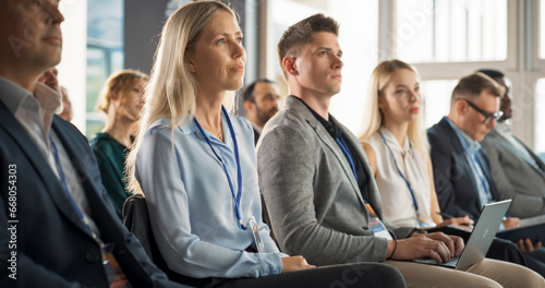 Young Female Psychologist Attending an International Cognitive Behavioral Therapy Seminar. Caucasian Woman Focused on Presenter. Psychotherapy Professional Sitting in Crowded Room on Training Program.