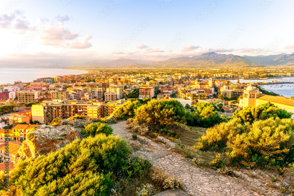 panoramic summer travel view from a hill to  beautiful sea coast historical town with port, amazing ocean bay and gulf and beautiful mountains with scenic sunset on background.