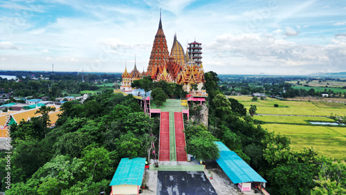Wat Tham Suea is a temple and tourist attraction have large Buddha image. Located on top of a hill is a beautiful view of the surrounding rice fields. Located at Kanchanaburi Province in Thailand. photo
