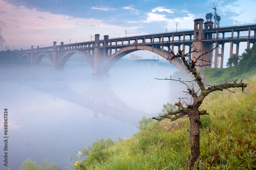 Foggy Dnieper under Preobrazhensky bridge, view from the Khortytsia island, Zaporizhzhia, Ukraine