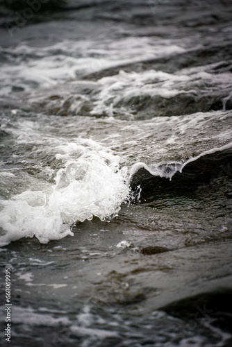 water has very rough waves in the ocean  and it looks like foamy