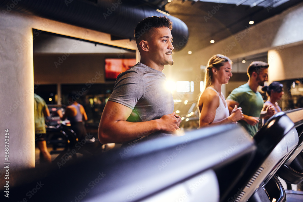 Man running on a gym treadmill Man running on a gym treadmill