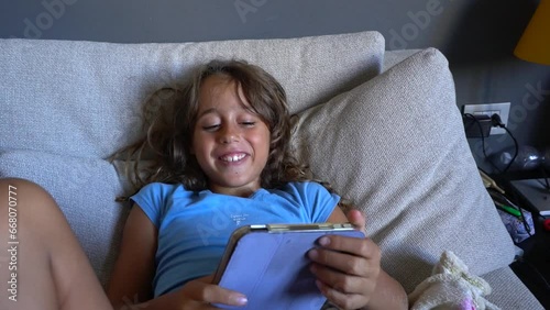 girl playing with tablet and laughing