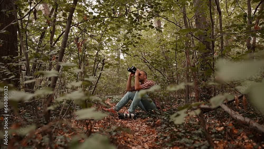 Man using binoculars and camera for birdwatching and other observing animals in nature. Man using binoculars and camera for birdwatching and other observing animals in nature.