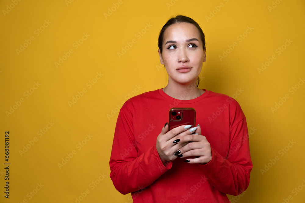 Portrait of attractive cheerful girl using device gadget app smm post isolated over bright yellow color background Portrait of attractive cheerful girl using device gadget app smm post isolated over bright yellow color background