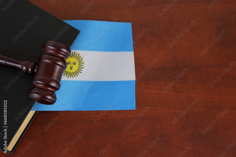 Wooden gavel on legal book with flag of Argentina on table. Copy space for text.