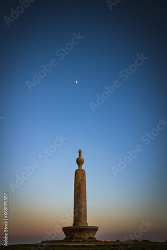 memorial monument Codden hill at sunset with the moon above.
