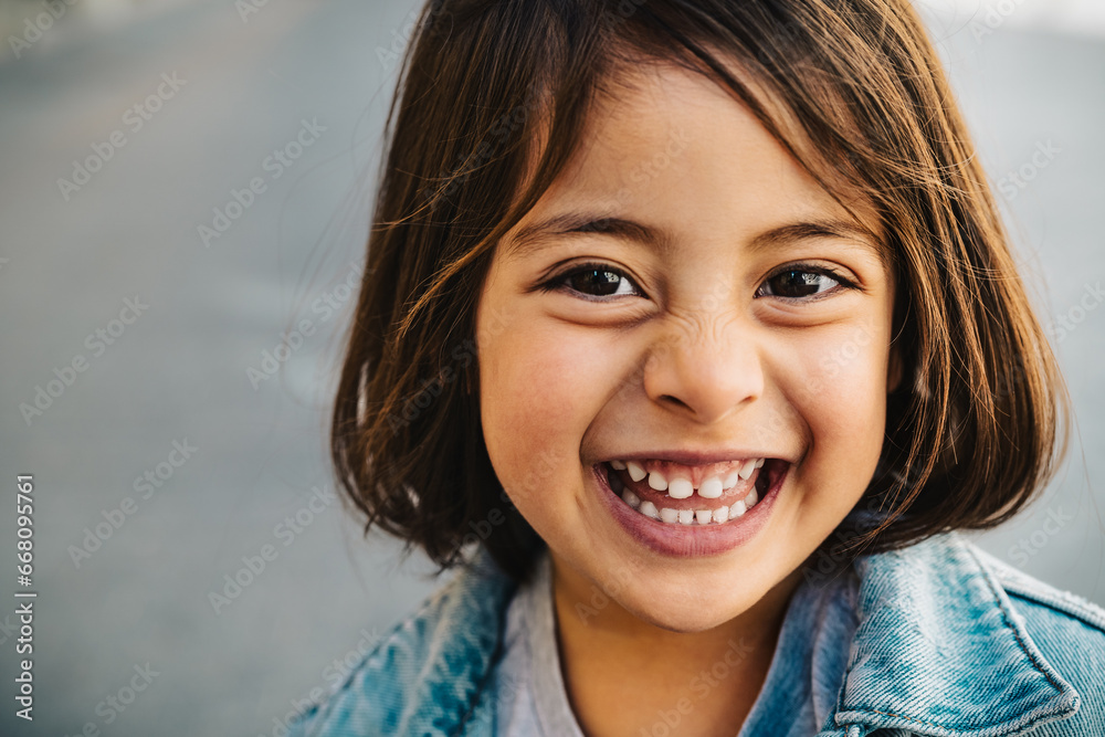 Happy child having fun smiling into the camera Happy child having fun smiling into the camera