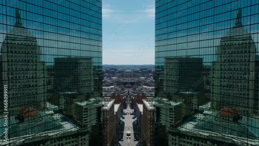 Fly around modern office downtown skyscraper with glossy glass facade reflecting surrounding town development. Boston, USA. Abstract computer effect digital composed footage