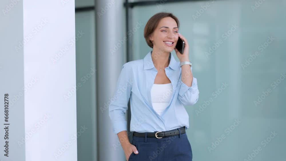 Business woman standing at the office and using phone Business woman standing at the office and using phone