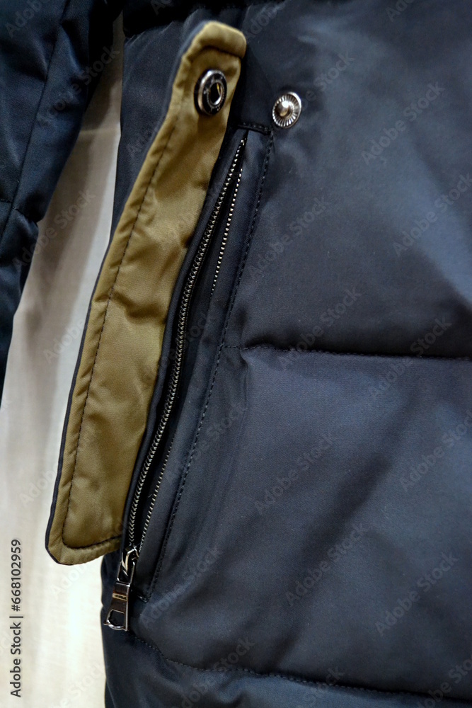 sleeve and pocket of a men's winter jacket with zippers and fasteners on an isolated background sleeve and pocket of a men's winter jacket with zippers and fasteners on an isolated background
